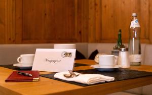 a table with a napkin and utensils on it at ... mein romantisches Hotel Toalstock in Fiss