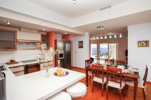 a kitchen and dining room with a table and chairs at Villa Plaža in Zavala +37 photos