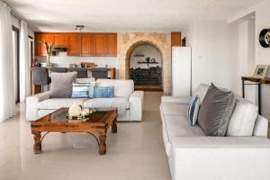 a living room with two couches and a coffee table at Villa Thea in Peyia