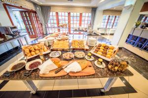 a table filled with lots of different types of food at Birchwood Hotel and OR Tambo Conference Centre in Boksburg