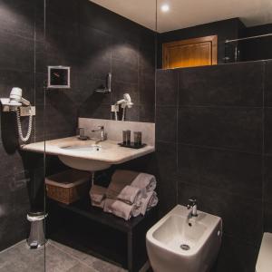 a bathroom with a sink and a toilet at Hotel Aquadulci in Chia