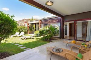 a house with a patio and a garden at Tauro Golf by VillaGranCanaria in Puerto Rico de Gran Canaria