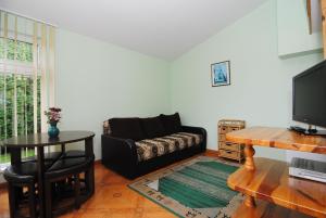 a living room with a couch and a table at Palangos Saulegraza in Palanga
