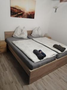 a bed with two pillows on it in a room at Haus Pucher in Sankt Florian am Inn