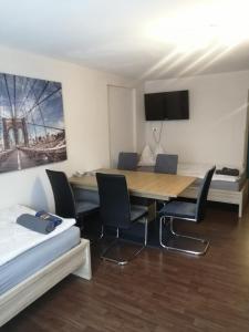 a room with a table and chairs and a bed at Haus Pucher in Sankt Florian am Inn