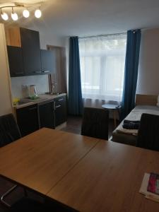 a room with a table and a kitchen and a bed at Haus Pucher in Sankt Florian am Inn