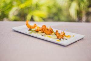 a plate of food with shrimp on a table at Hotel Aquadulci in Chia