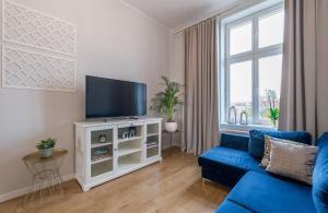 Televízia a/alebo spoločenská miestnosť v ubytovaní Apartament Diamentowy