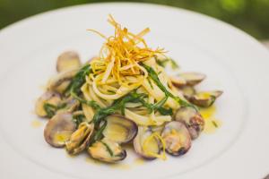 a plate of food with mushrooms and vegetables on it at Hotel Aquadulci in Chia