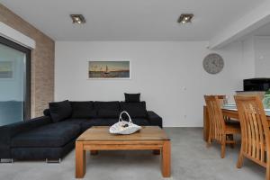 a living room with a black couch and a table at Luxury apartment Macola Free beach parking in Makarska