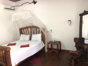 Letto o letti in una camera di Sigiri Lion Lodge