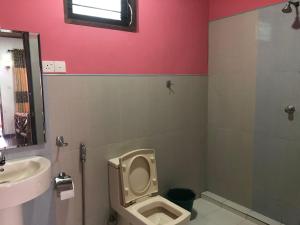 a bathroom with a toilet and a sink at Sigiri Lion Lodge in Sigiriya