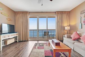 a living room with a couch and a tv at Calypso Resort in Panama City Beach