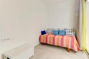 a bedroom with a bed in a white room at Beachfront Apartment Migjorn Playa in Colònia de Sant Jordi