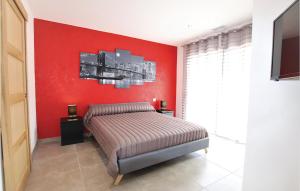 a bedroom with a red wall and a bed at Stunning Home In Monteux in Monteux +16 photos