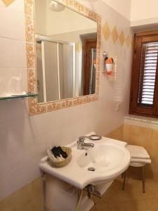 a bathroom with a sink and a mirror at Il Casale Del Cotone in San Gimignano