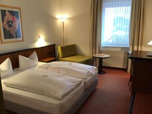 Postel nebo postele na pokoji v ubytování Garni Hotel Schmaus