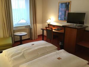 Postel nebo postele na pokoji v ubytování Garni Hotel Schmaus