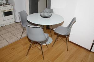 - une table et des chaises blanches dans la cuisine dans l'établissement Apartman Zen, à Osijek