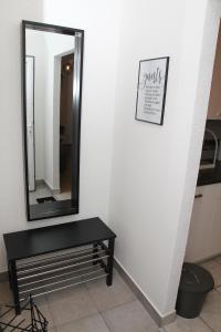 a mirror and a black table in a room at Apartman Zen in Osijek