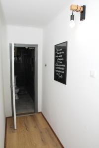 a chalkboard sign on a wall next to a bathroom at Apartman Zen in Osijek