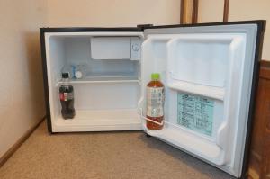an open refrigerator with drinks inside of it at Guesthouse Arakura ,Private 2F Stay ,Walk to Chureito Pagoda in Fujiyoshida