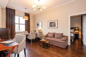 a living room with a couch and a dining room at Arabel Design Apartments in Berlin