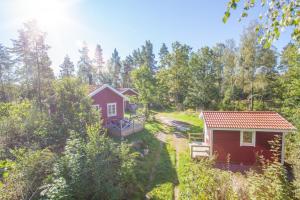 an aerial view of two cottages in the woods at Maren 1 in Mörlunda