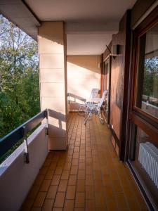 a balcony of a house with a chair on it at Hotel Quellenhof Bad Urach in Bad Urach