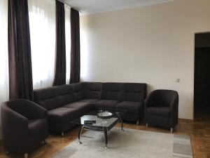 a living room with a couch and a table at Hotel Sofiivka in Konopnitsa