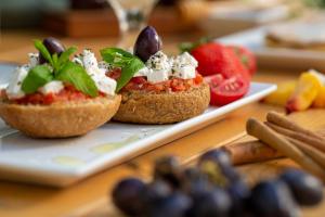 two sandwiches on a plate on a table at Pavlos Hotel in Kos Town