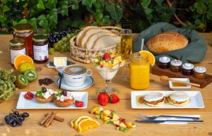 a table with food and a loaf of bread and fruit at Pavlos Hotel in Kos Town