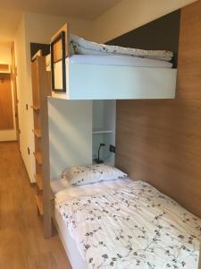 a bedroom with two bunk beds in a room at Apartma Rogla - Gaber 98 in Resnik