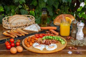 a wooden table with eggs and vegetables on a cutting board at Pavlos Hotel in Kos Town