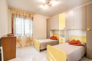 a bedroom with two beds and a window at Magdalene's House - sea view terrace in Massa Lubrense