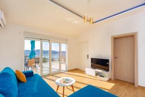 a living room with a blue couch and a tv at Apartment Stojanovic in Bar