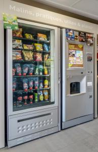 a vending machine in a store with food and drinks at B&B HOTEL Maubeuge-Louvroil in Louvroil