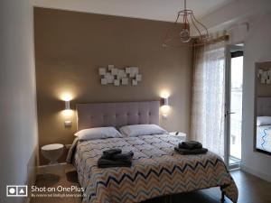 - une chambre avec un lit et 2 serviettes noires dans l'établissement La Casa Dei Nonni, à Matera