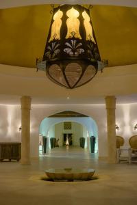 a large chandelier hanging from a ceiling in a room at Swahili Beach in Diani Beach