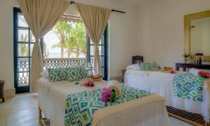 Een bed of bedden in een kamer bij Swahili Beach