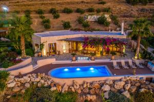 an aerial view of a house with a swimming pool at East Crete Villa Mirabello in Kavoúsion