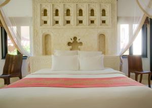 Een bed of bedden in een kamer bij Swahili Beach
