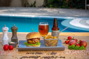 a sandwich and a glass of beer on a table at Pavlos Hotel in Kos Town
