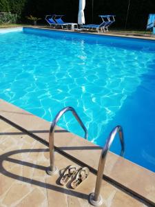 un par de chanclas sentadas junto a una piscina en Agriturismo Il Morello, en Acquapendente