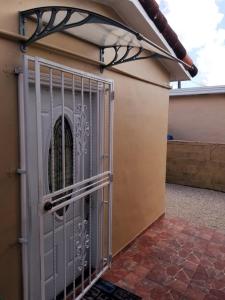 a gate on the side of a house at Guayabita's House in Miami
