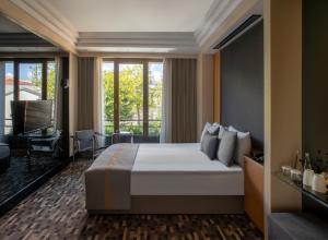 a hotel room with a large bed and a balcony at Tan Hotel - Special Category in Istanbul