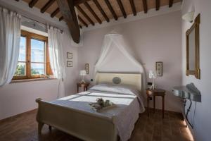 a bedroom with a bed with a teddy bear on it at Villa dei Tramonti in Passignano sul Trasimeno +62 photos