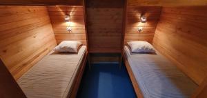 two beds in a sauna with wooden walls at Tuksi Health and Sports Centre in Tuksi