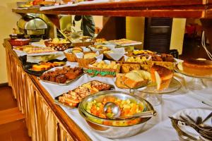 a buffet with many different types of food on a table at Hotel Estoril in Pelotas