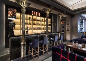 a bar at a restaurant with blue chairs at Elite Apartments Sopot Admiralski przy plaży in Sopot